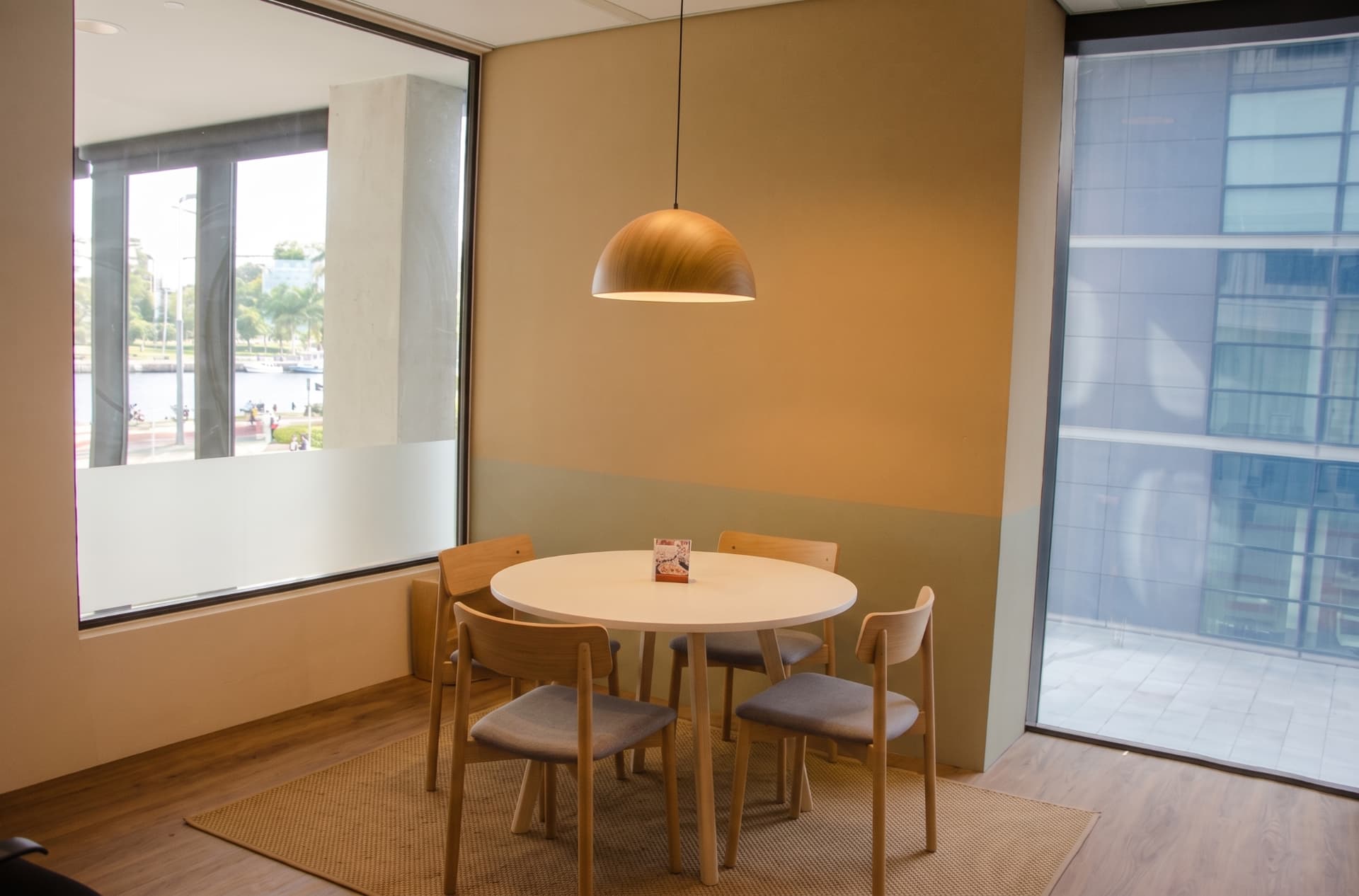 Compact studio meeting room with warm timber details